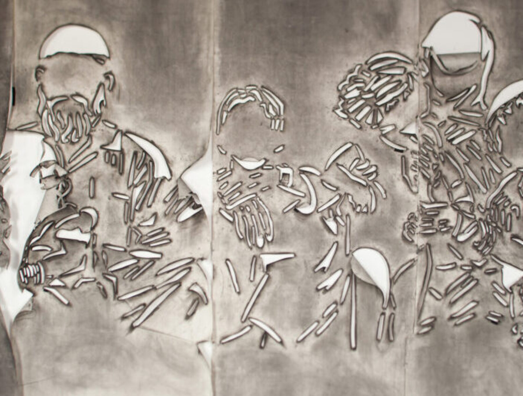 Five panels of paper covered in gray charcoal in which there is a cut stencil of an image of a group of faceless people. The panels have portions of paper that flap and fold.