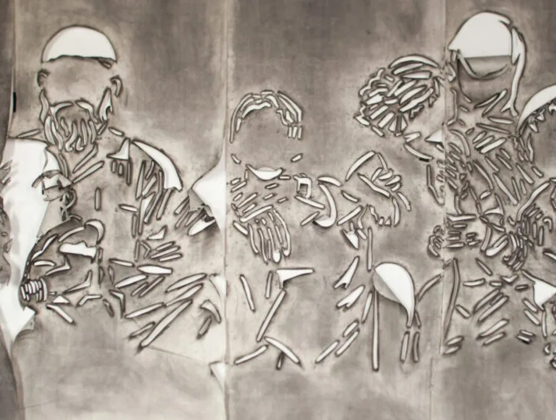 Five panels of paper covered in gray charcoal in which there is a cut stencil of an image of a group of faceless people. The panels have portions of paper that flap and fold.
