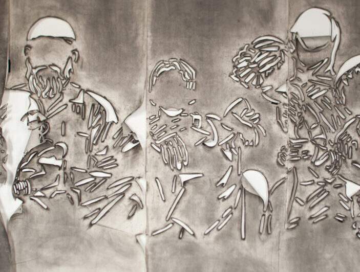 Five panels of paper covered in gray charcoal in which there is a cut stencil of an image of a group of faceless people. The panels have portions of paper that flap and fold.