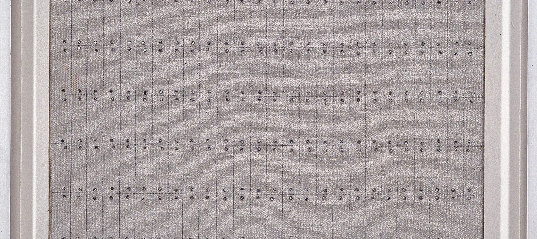 Painting with nine by twenty-six grids formed by pencil on a textured, gray background. Tiny silver nail heads hug the top and bottom of each section. Exact in design, the effect is one of imperfection as the lines are not perfectly straight and the nails do not totally line up.