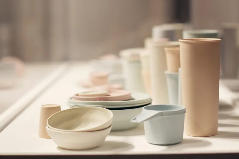 A large collection of pastel, ceramic vessels resembling stacks of myriad Tupperware.