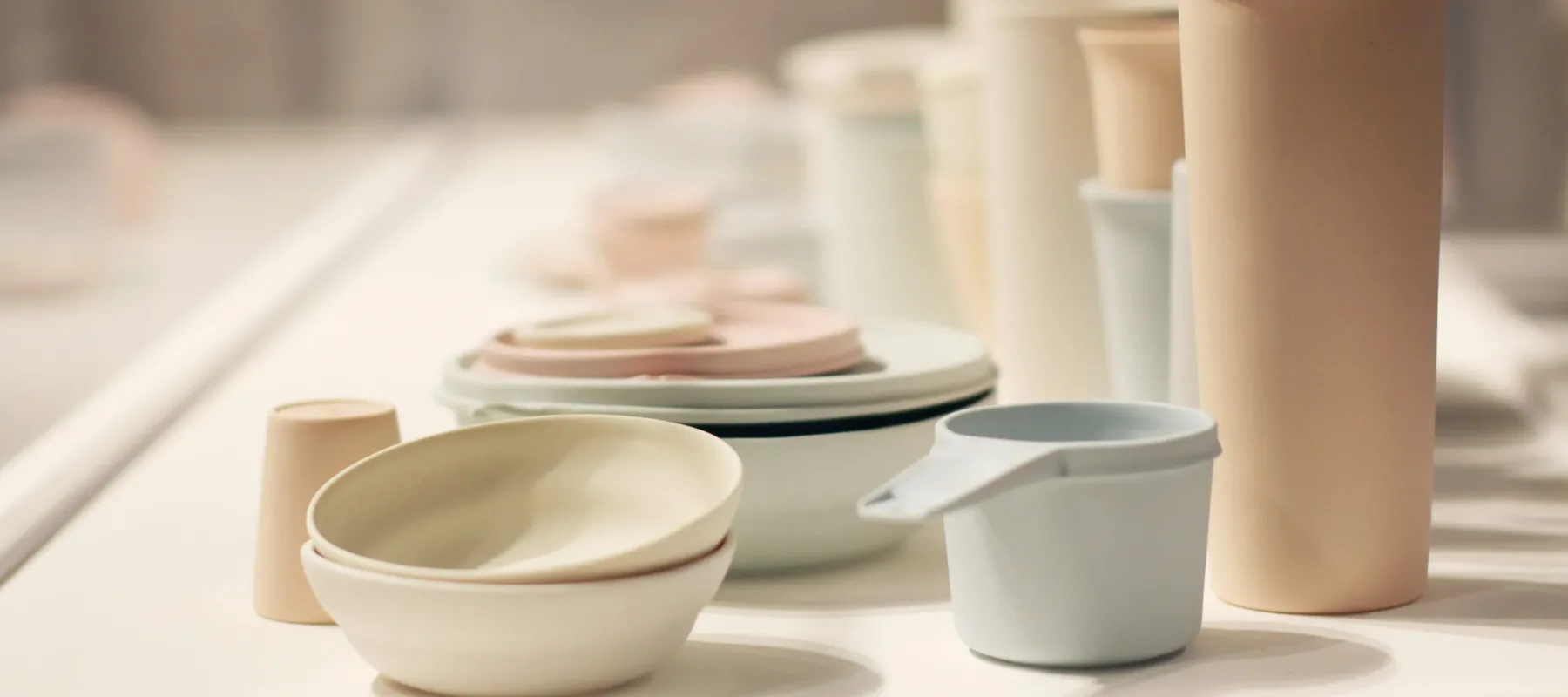 A large collection of pastel, ceramic vessels resembling stacks of myriad Tupperware.