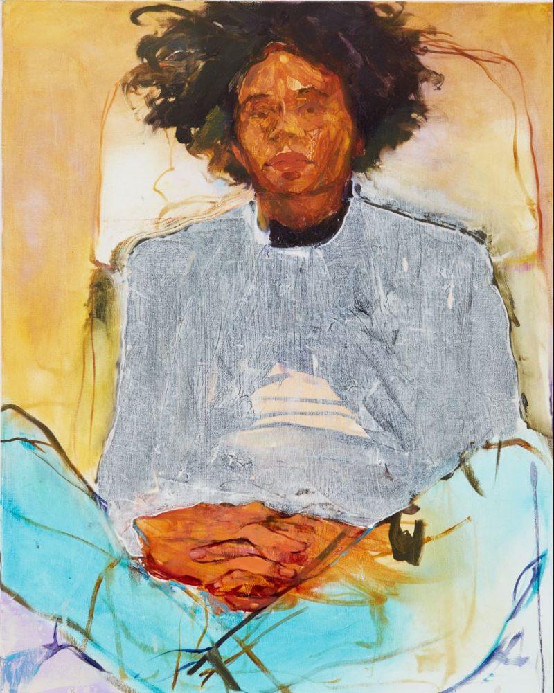 A figurative oil painting featuring a dark-skinned man with a loose afro sitting in a relaxed pose with his legs crossed and hands folded in his lap. He leans against a wall or seat, his expression is placid and he looks directly at the viewer.