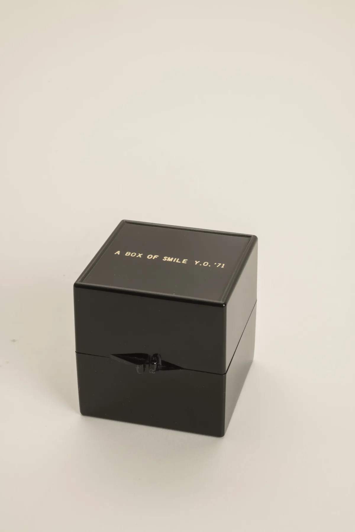 A small black square box that has "A Box Of Smile, Y.O. '71" printed on the lid.