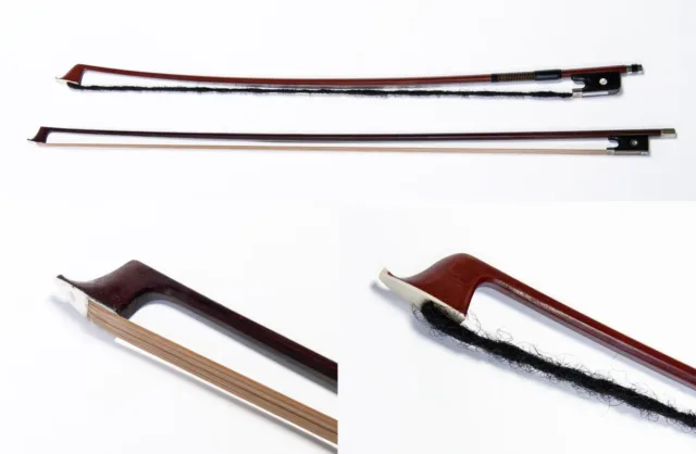 Two wooden violin bows, one strung with straight, smooth blond hair, and the other strung with a dark dreadlock, made from human hair.