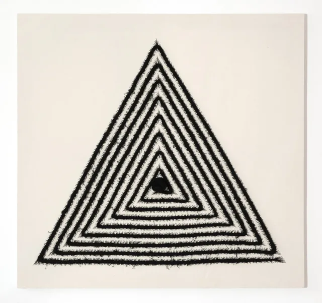 An off-white, square canvas with a large equilateral triangle in the center made from stitched black cotton thread. The thread has been braided, as a cornrow, in a triangular spiraling patter than ends with a large knot in the center of the triangle.