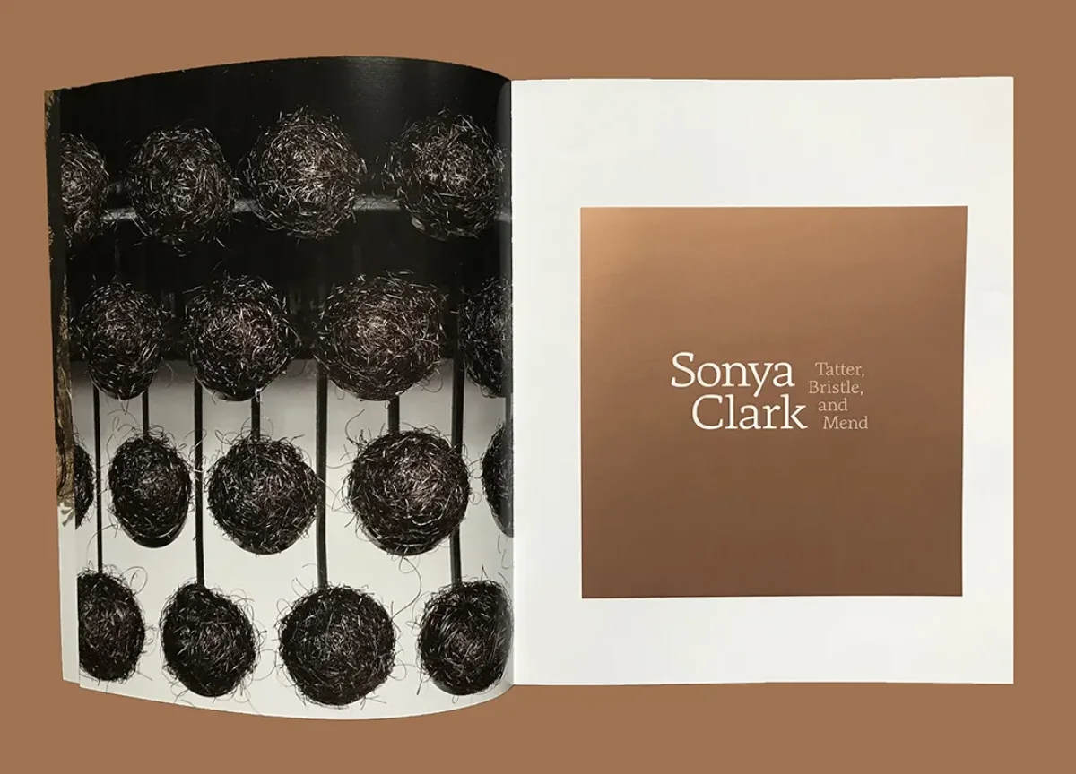 Look inside a book with a photograph of an organic art work on one page and the title "Sonya Clark."