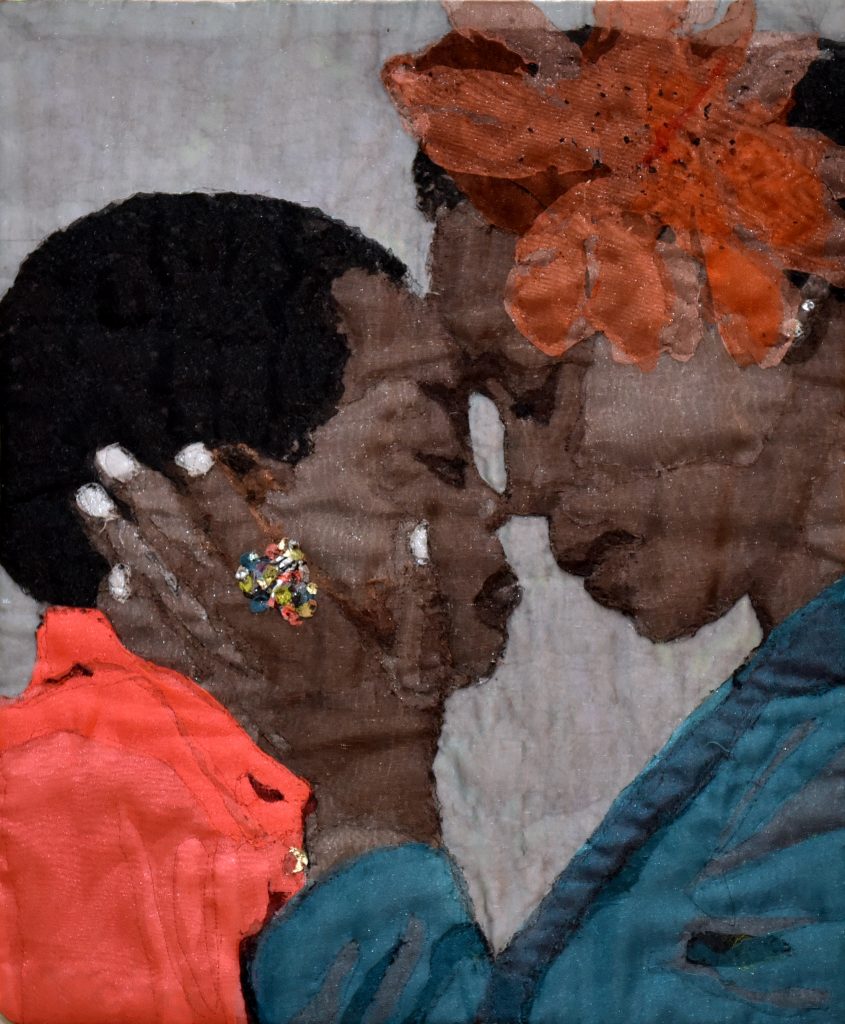 An image sewn as a quilt of a dark-skinned woman, wearing a large orange flower in her hair, holding the face of a dark-skinned child in her hands as they touch their foreheads and noses together lovingly.