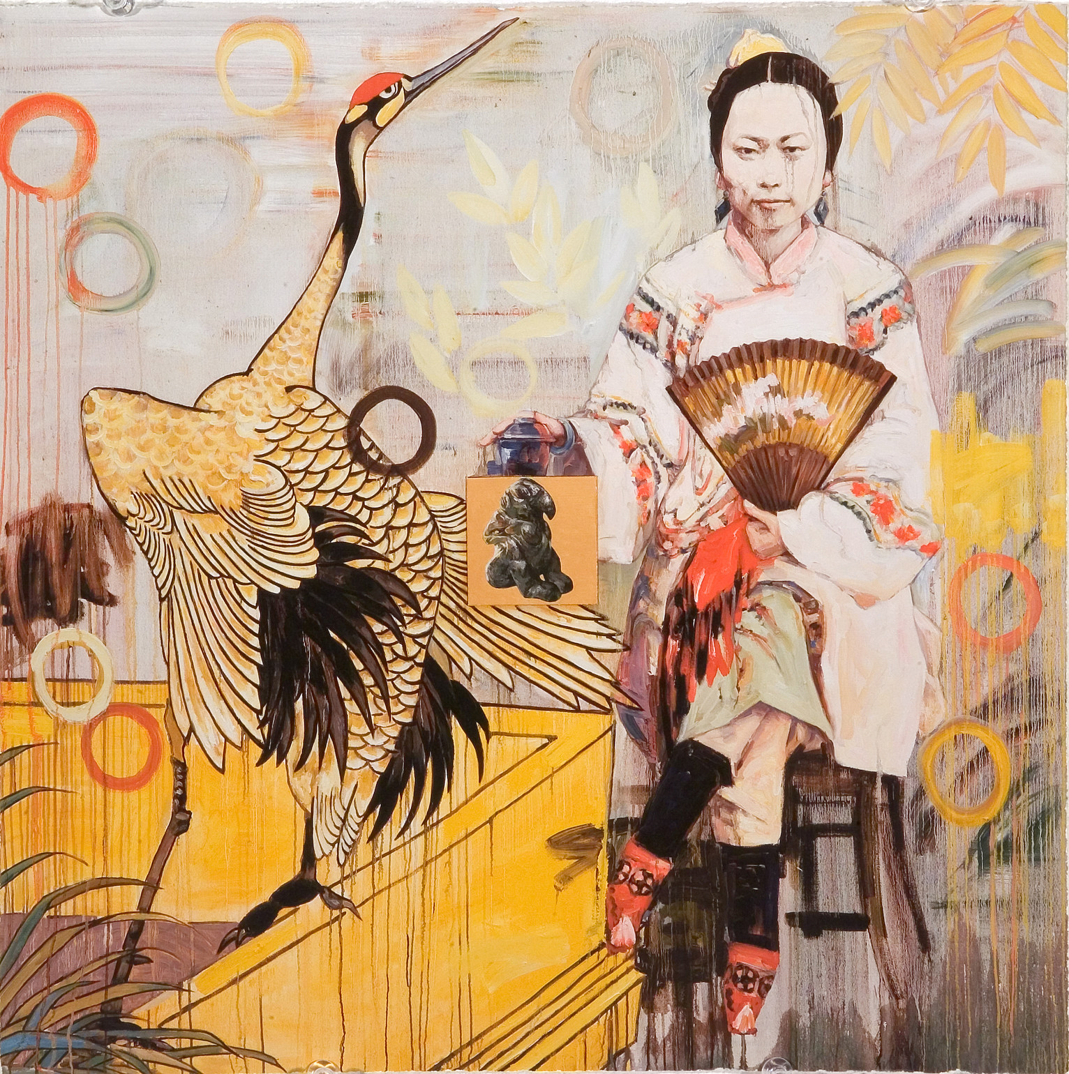 A painting of a light skinned Chinese woman with dark brown hair sitting cross-legged on a stool gazing out at the viewer. The woman wears a light pink robe with coral flowers on the sleeves. She holds a gold fan with light pink flowers. Her hand rests on a square object with a rounded lid. On the left side of the painting a white and black crane with a red crown lifts its head to the sky.