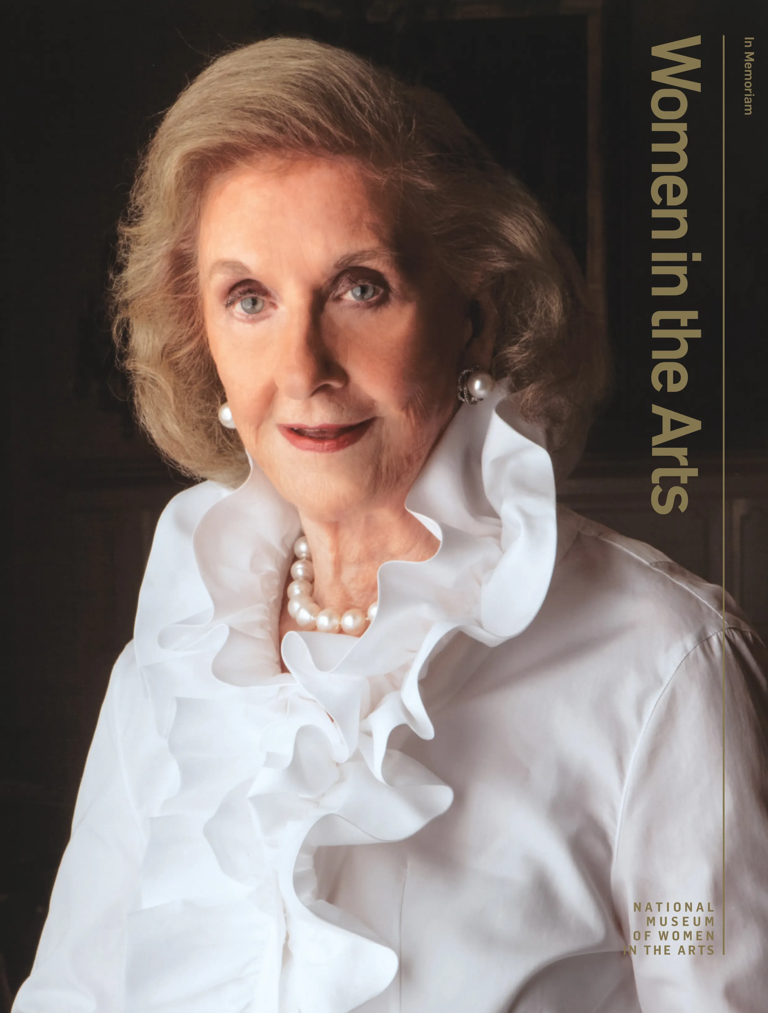 Cover of 'Women in the Arts' magazine featuring a professional portrait of Wilhelmina Cole Holladay. She is a light-skinned, older woman with a blonde bob. She wears an elegant white ruffled blouse and pearl jewelry.