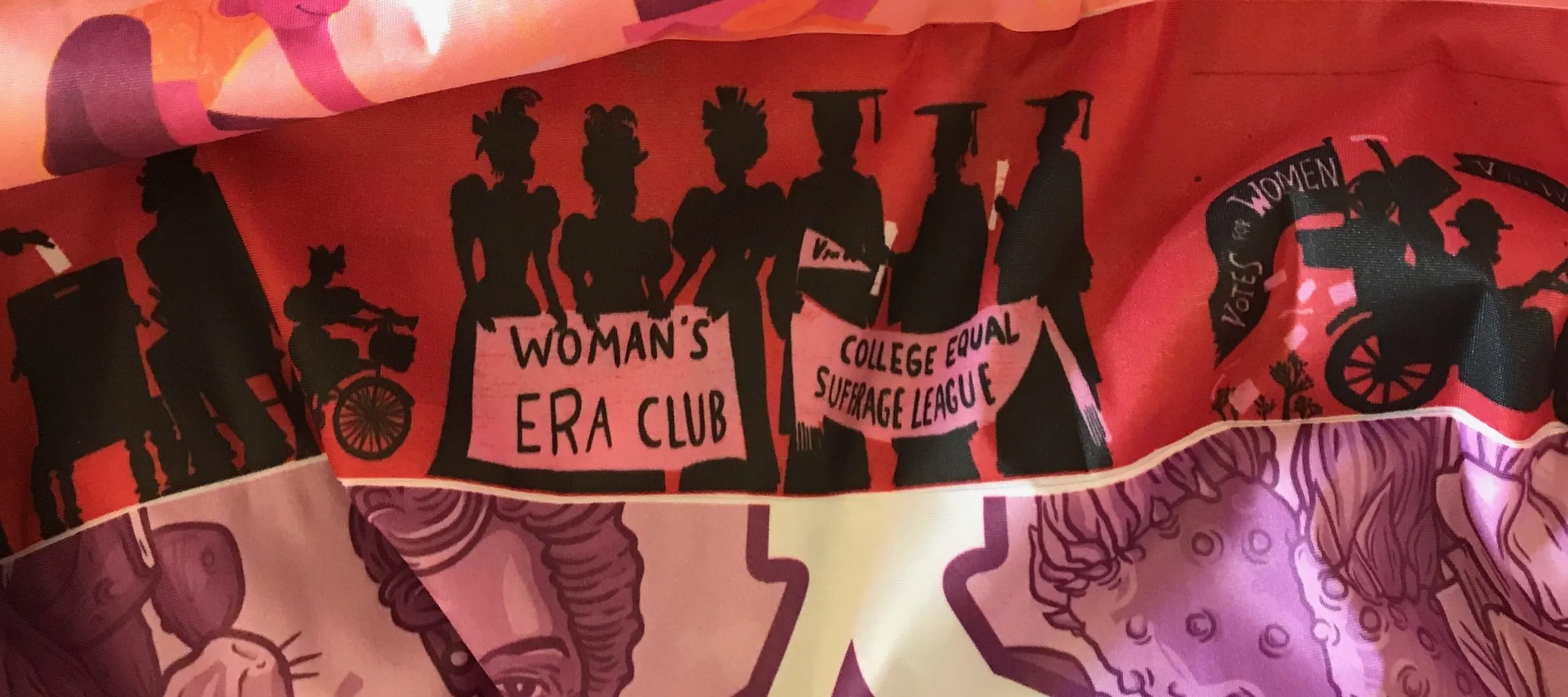 Detail of the stripes on "Her Flag.” One stripe depicts images of a dark-skinned woman going from childhood to graduation to an image of the woman as a young adult on a VOTE sign. The next stripe depicts a group of six women in silhouette. The three women on the left are wearing dresses from the late nineteenth century and hold a sign that reads “Woman’s Era Club,” the three women on the left are wearing graduation caps and gowns, holding a sign that reads “ College Equal Suffrage League.”