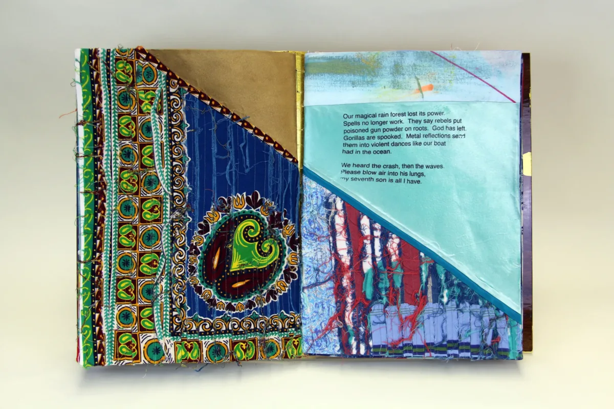 A book made from colorful print fabrics collaged and stitched together is laid flat and open to a spread that features a vibrant African prints and a short poem.