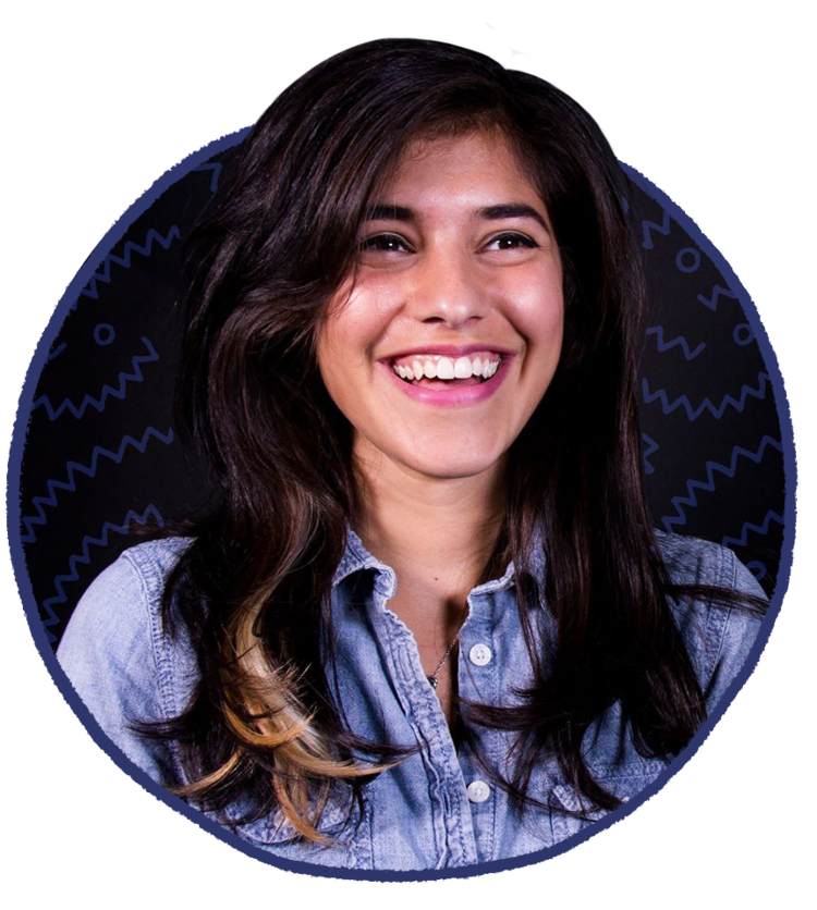 A medium-light skinned young woman with long, wavy dark brown hair is pictured from the chest up, smiling happily and looking out to the right. She wears a denim button-up shirt and the photo is arranged in a graphic circle.