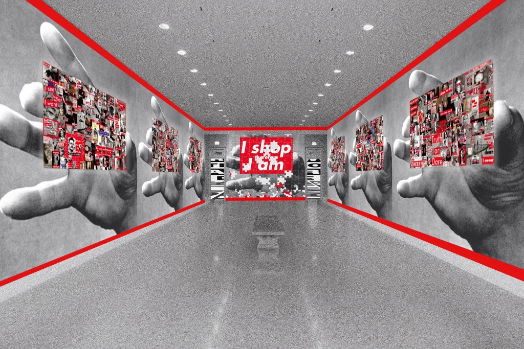 A rendering of a museum entryway features shiny, stark white floors and a low bench in the middle of the passage. On all of the walls, large black-and-white photos of a hand, mid-reach, are overlaid with busy collages of unknown photos that are marked with red. At the very back wall the phrase "I shop therefore I am" is prominently displayed in white text on a red square background atop one of the hands.