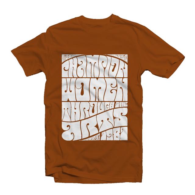 Rust-colored t-shirt features NMWA’s slogan, “Champion Women through the Arts,” in white psychedelic lettering.