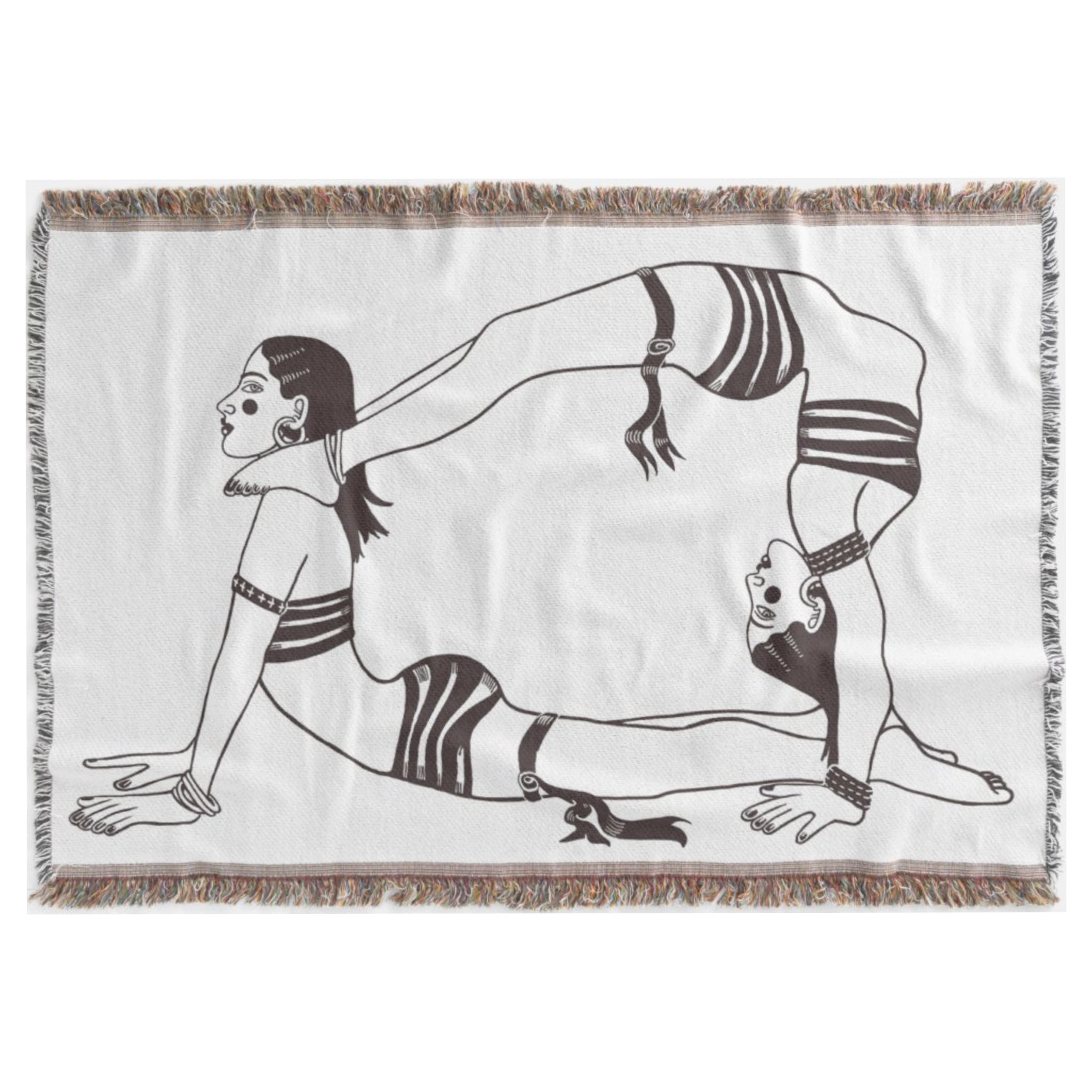 A large woven throw blanket with slightly fringed edges features a black-and-white illustration of two acrobatic women. One is on the floor in the upward facing dog yoga position and the other is above her, in an opposite position where her feet are resting on the women's shoulders, her torso is extended, and her hands are on the floor so she is in an elegant backbend position. Both wear small bikini tops and bottoms.