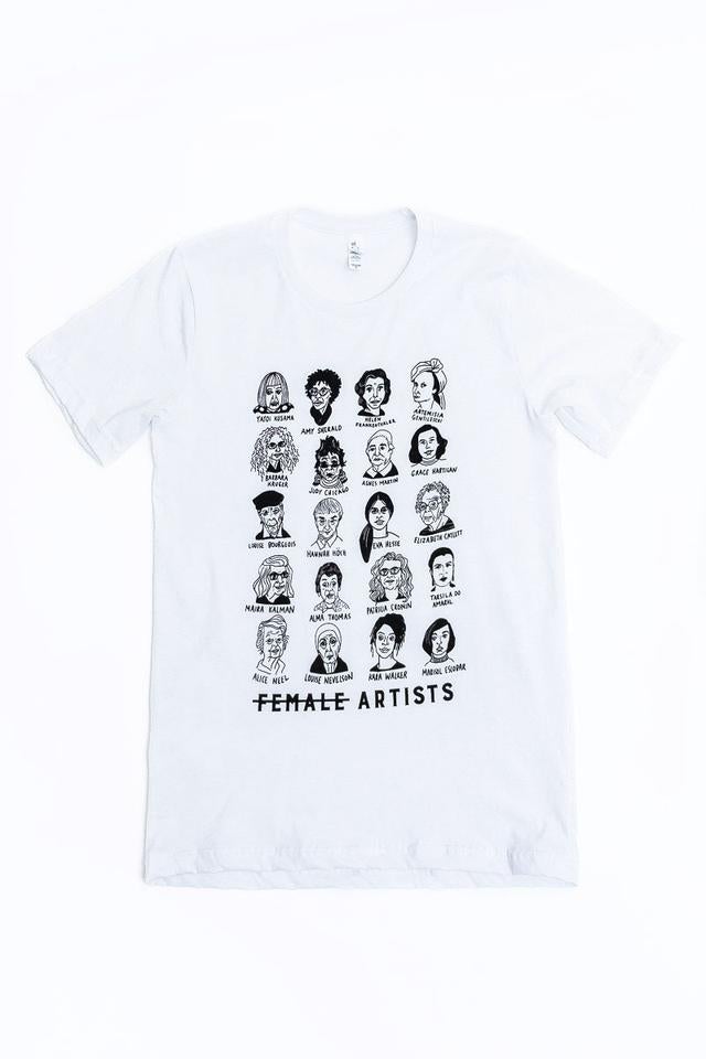 A white T-shirt features a central illustrated grid in black ink of five rows each featuring four portraits of women artists throughout history. Each has their name written below the image. At the bottom of the grid, in bold text, the words "FEMALE ARTISTS" are written, with a strikethrough on the word "Female."