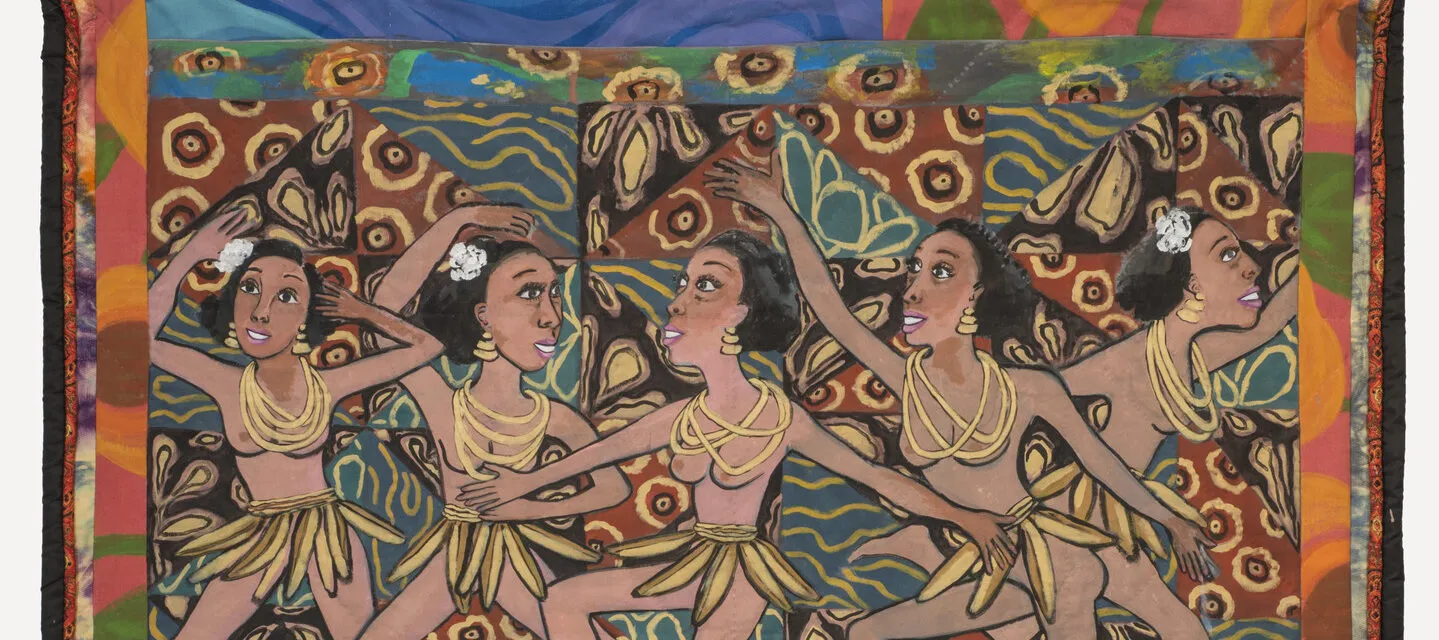 Colorful quilt with a multi-patterned background that depicts five medium skin toned, bare breasted dancing women wearing skirts of bananas and yellow necklaces. Below, from left to right, a medium-dark skin toned and light skin toned men and women interact and play brass instruments.