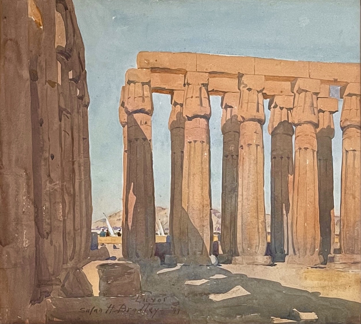 A watercolor painting features a scene of ancient Egyptian columns painted in an earth-tone, half lit from the sun and half under shadows from the structures surrounding it. The sky is a clear blue.