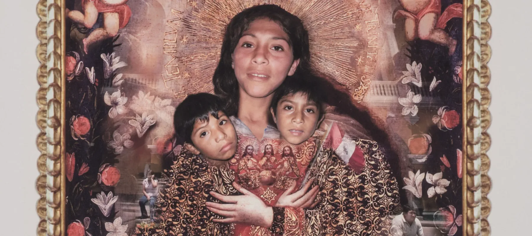 A classical depiction of the Virgin Mary is paired with the face of a dark-haired, medium-skinned woman who is clutching the faces of two young boys. Around the edges of the photograph, the young boys and another young girl's face are patched onto floating cupid-like bodies.
