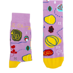 A pair of light purple socks with yellow, green, and blue abstract shapes on it. 