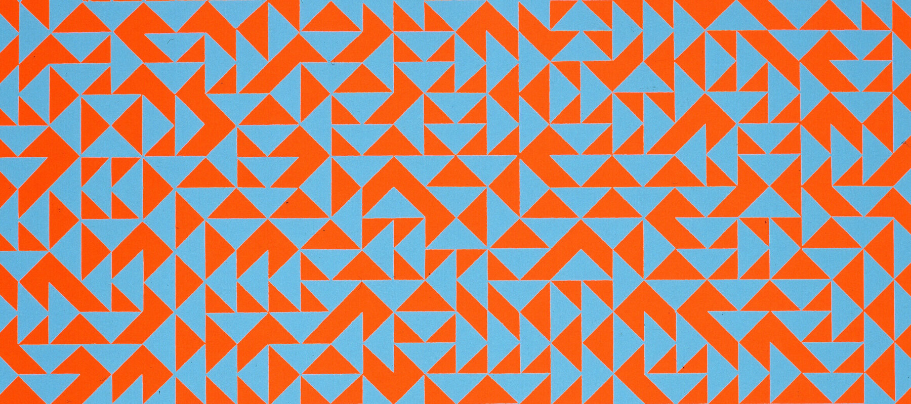 Rectangular print features hundreds of small, vibrant blue and red triangles arranged in geometric patterns, creating a quilt-like effect.