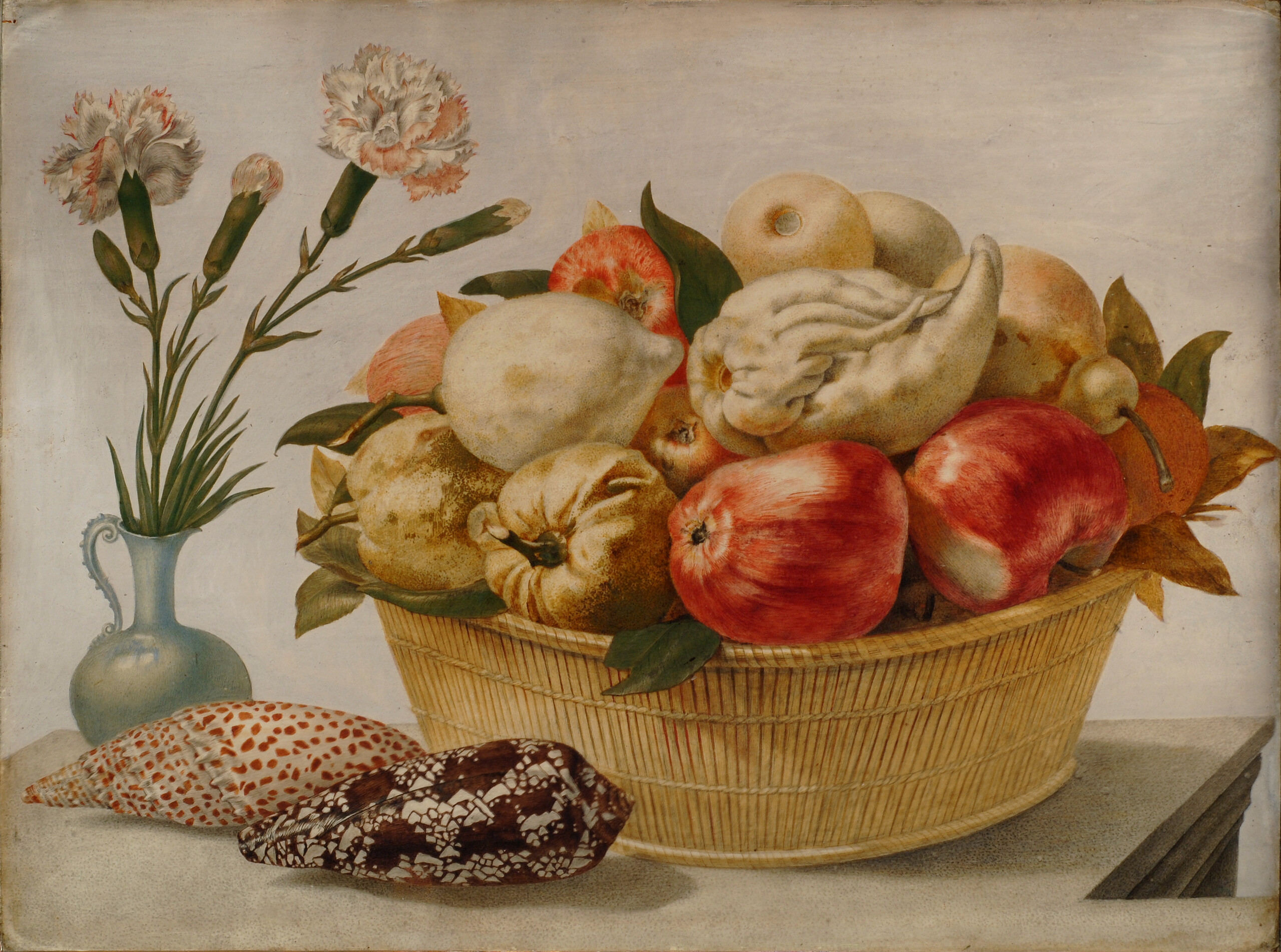 A round, straw basket filled with red apples and pale fruits and vegetables on a stone ledge against a light background. A light blue vase with pink and white carnations sits beside the basket. Two oblong, mottled seashells sit in front of the basket and vase.