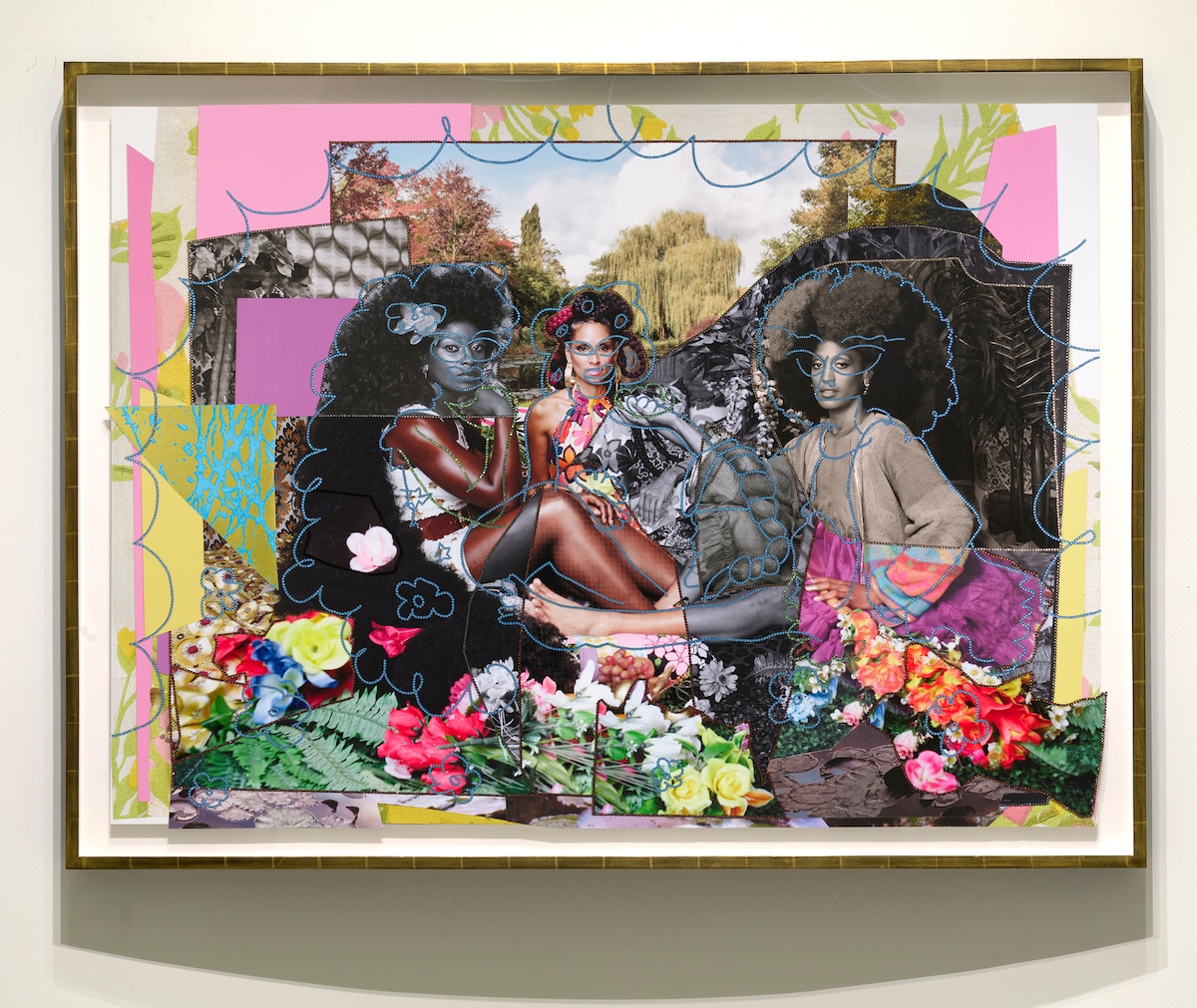 A mixed-media artwork shows three women with dark skin tones sitting in a park and looking at the viewer. The women’s figures are made of cut-out photographs in color as well as black and white, decorated with rhinestones. They are central in a collage that features a photograph of a park and shapes in colorful paper.