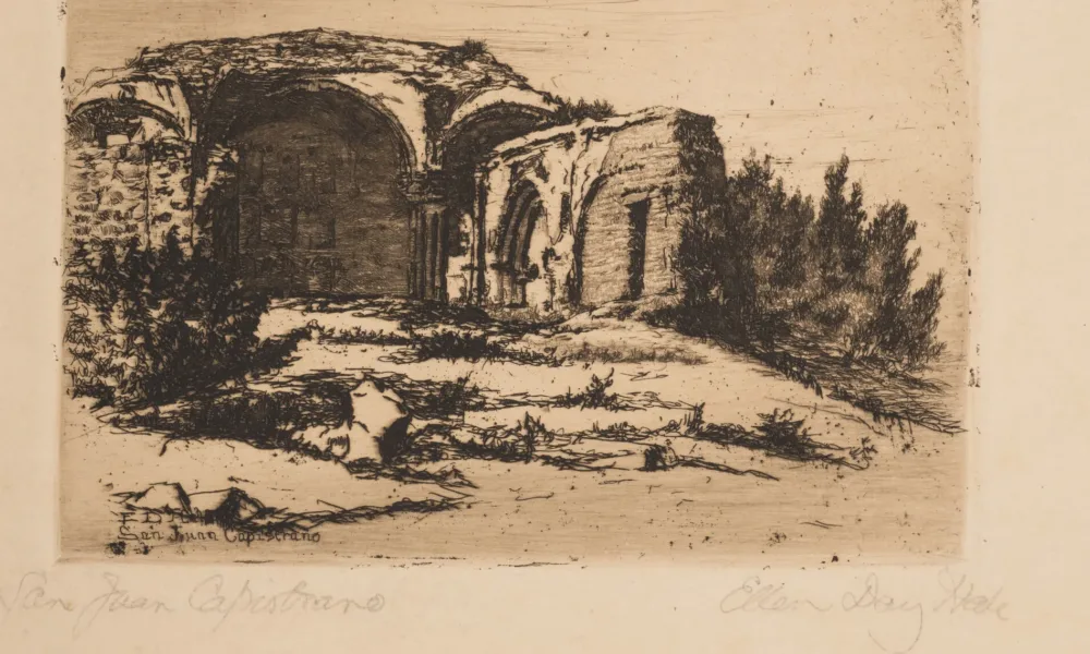 Small print of black ink on ecru paper depicting the ruins of an old Catholic mission building. The building, featuring rounded arches, crumbling facades, and exposed brick, is surrounded by scrub bushes and desert landscape.