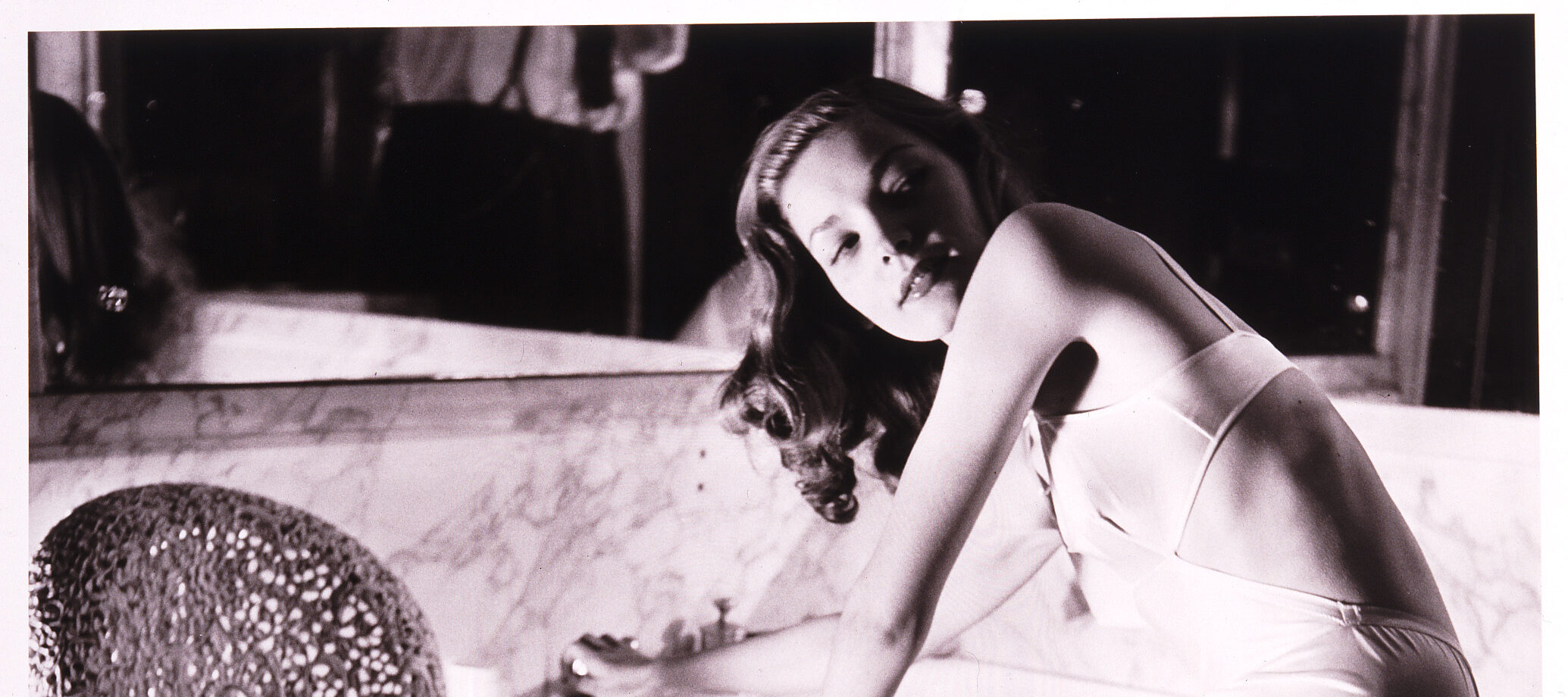 Louise Dahl-Wolfe, <em>Lauren Bacall in Helena Rubinstein's Bathroom</em>, 1943; Gelatin silver print, 14 x 11 in.; National Museum of Women in the Arts, Gift of Helen Cumming Ziegler; Photograph by Louise Dahl-Wolfe © 2023 Center for Creative Photography, Arizona Board of Regents/Artists Rights Society (ARS), New York 