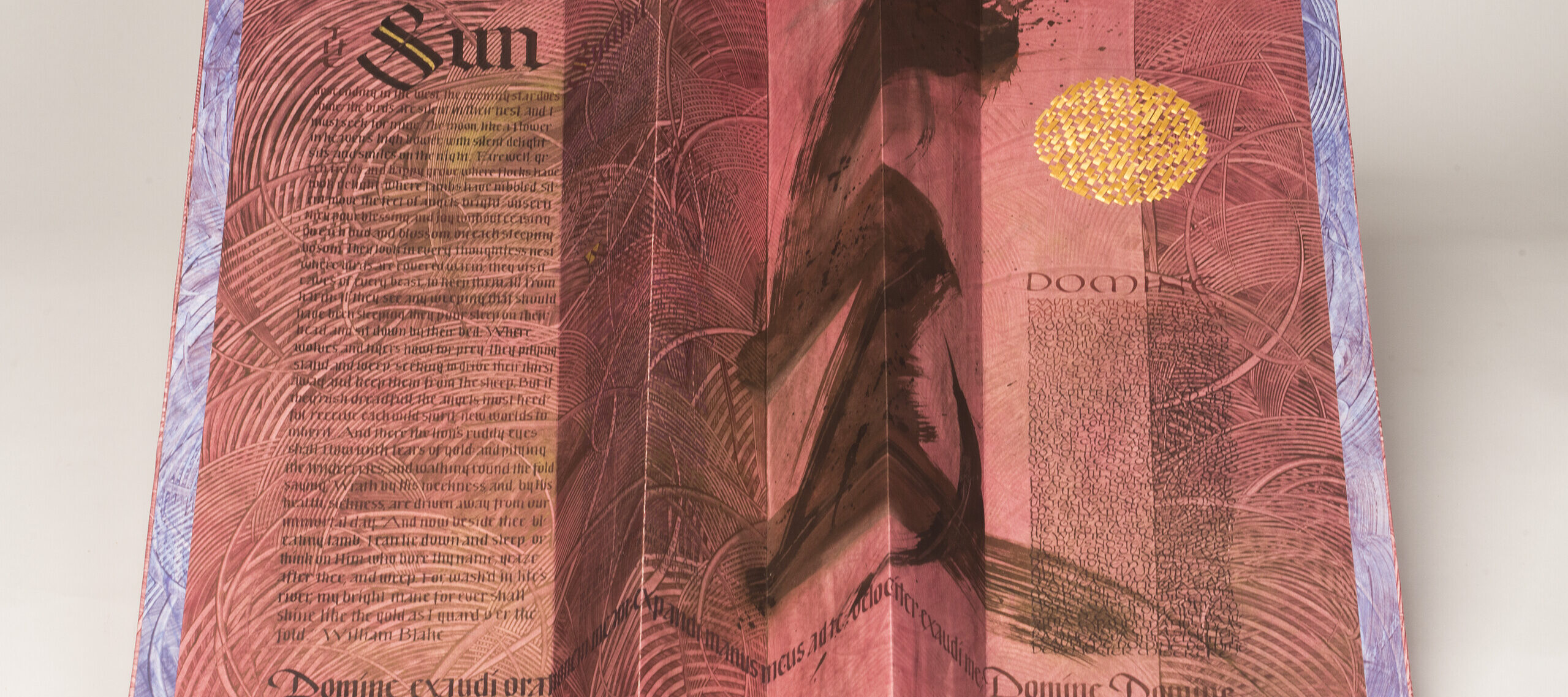 An open, accordion-style book with red-pink pages and black text. The word "Sun" is written in large, Gothic print at the upper left. At center-right is a large, black brushstroke that extends the length of the page. At the upper right is a golden circle.