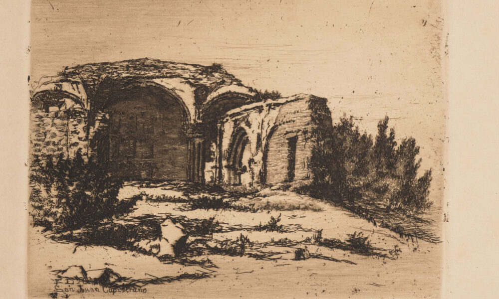 Small print of black ink on ecru paper depicting the ruins of an old Catholic mission building. The building, featuring rounded arches, crumbling facades, and exposed brick, is surrounded by scrub bushes and desert landscape.