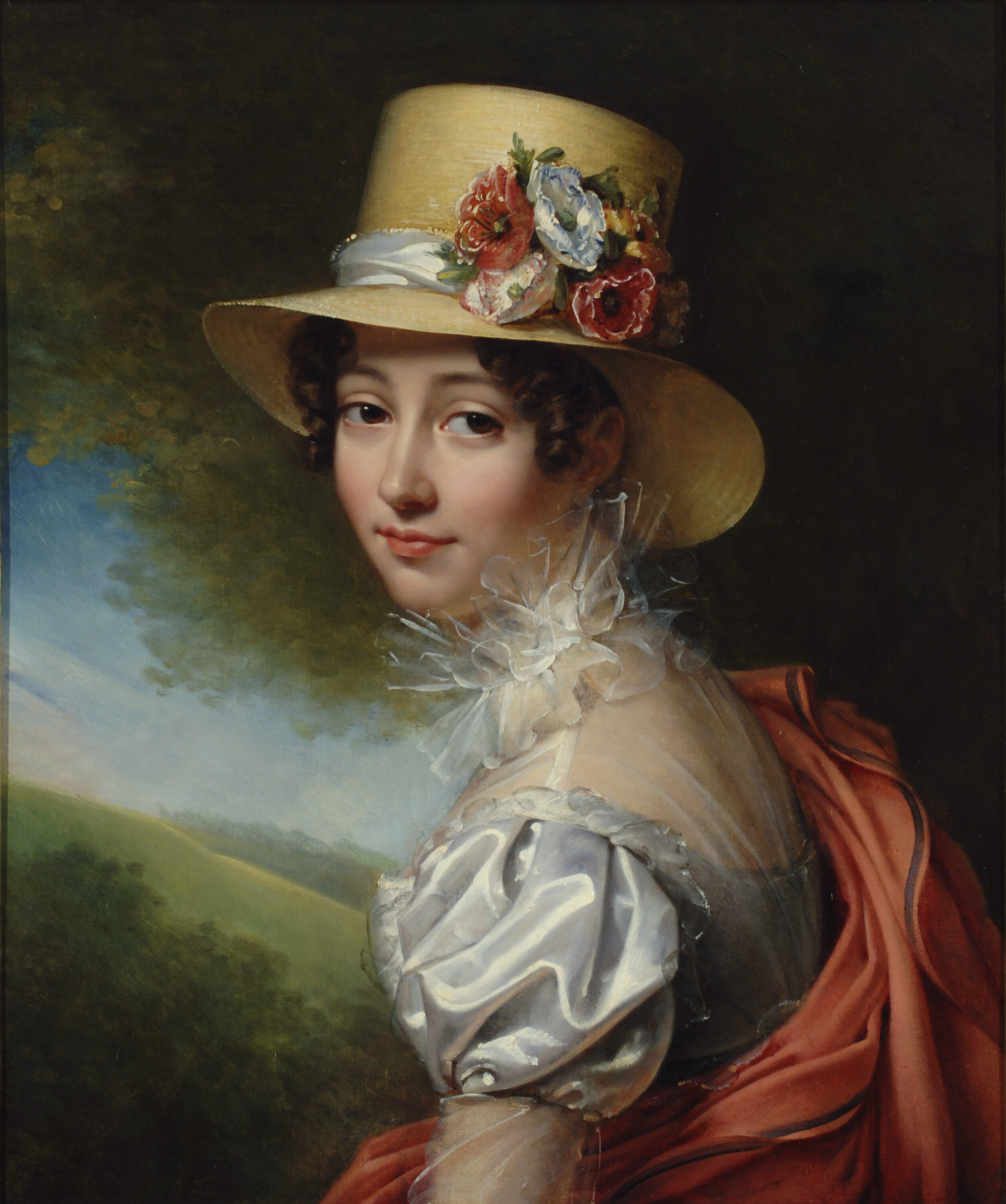 A 3/4 quarters portrait of a light skinned woman wearing a silvery blue puff sleeve gown with a gauzy, lacy collar. She is also wearing a red shawl and a brimmed hat adorned with flowers. She looks out at the viewer with a pleasant look.