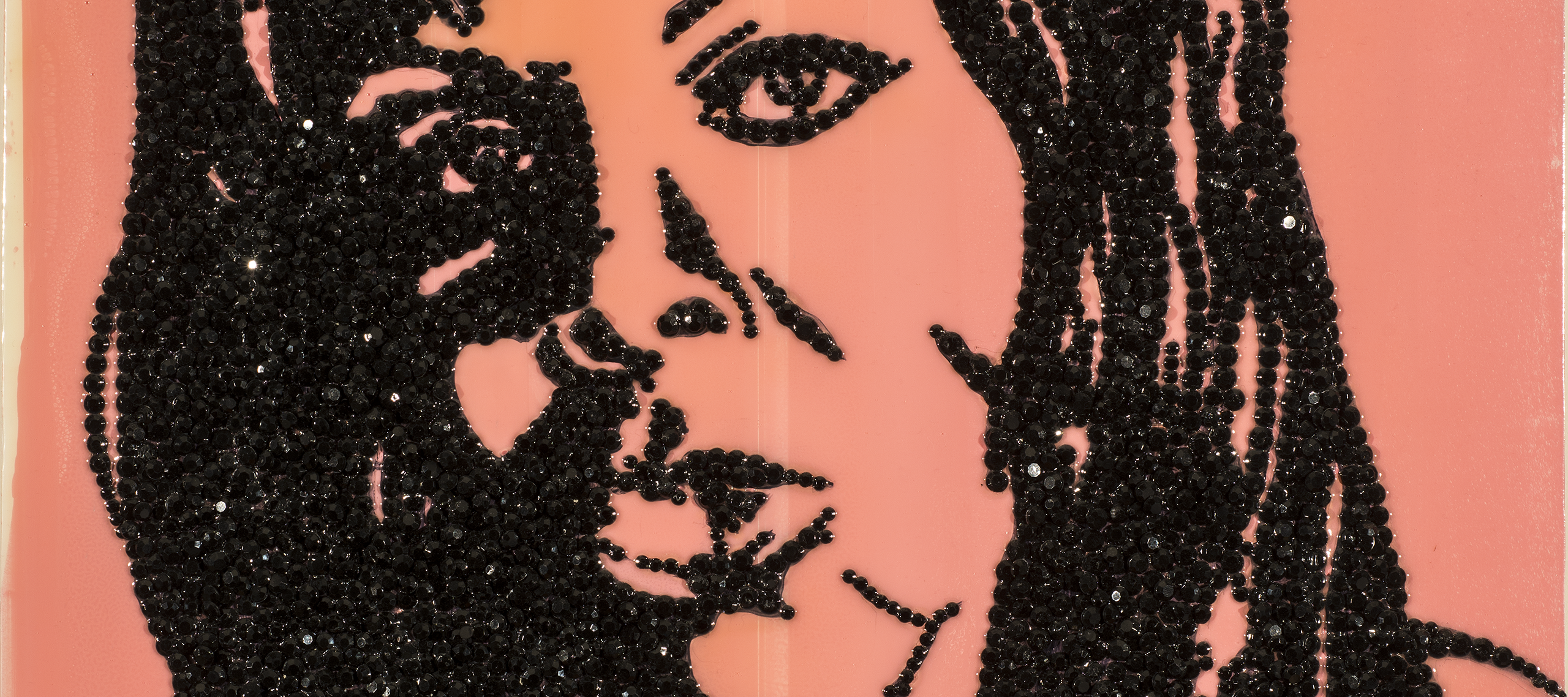An enamel portrait painting of a woman made with encrusted black rhinestones glued to shiny pink acrylic background.