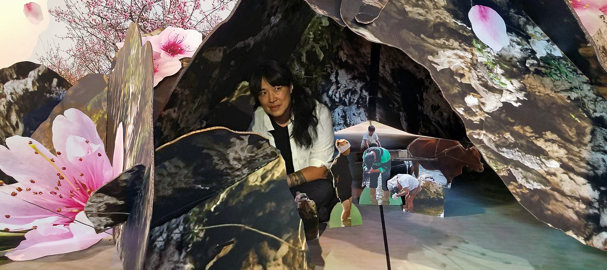 A three-dimensional photo collage of natural images creating a dome over images of five figures. The central figure is a light-skinned woman with long dark hair in a crouched position.
