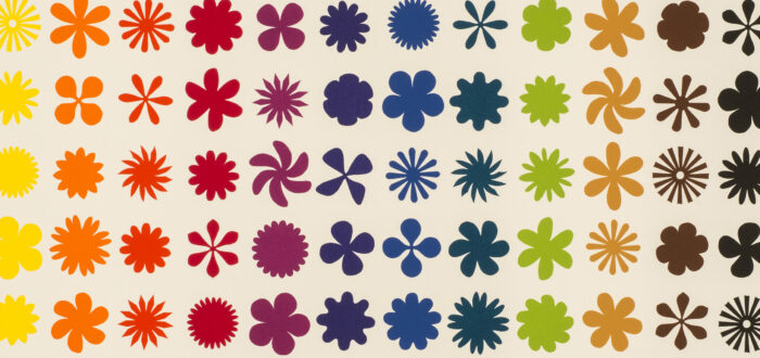 Twelve vertical columns, each a different color, of repeating flower, pinwheel, and starburst shapes on a white background.