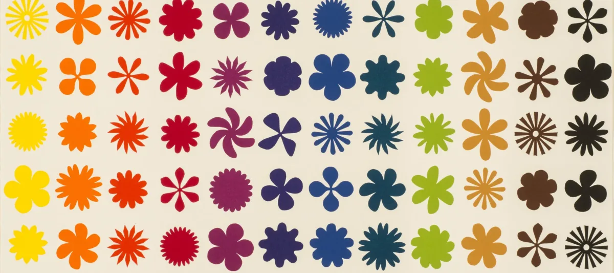 Twelve vertical columns, each a different color, of repeating flower, pinwheel, and starburst shapes on a white background.