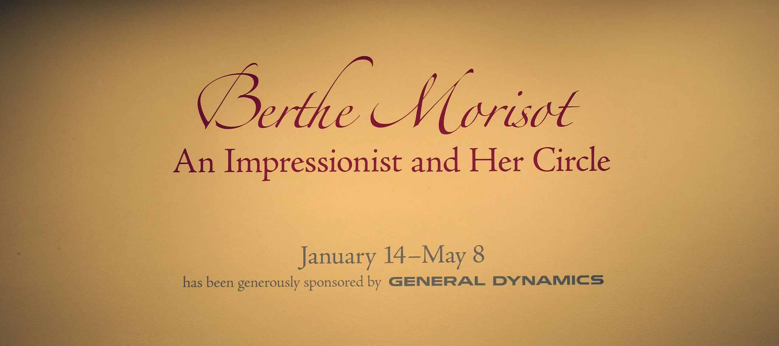 On a yellow wall, it says in big, red letters: "Berthe Morisot: An Impressionist and Her Circle".