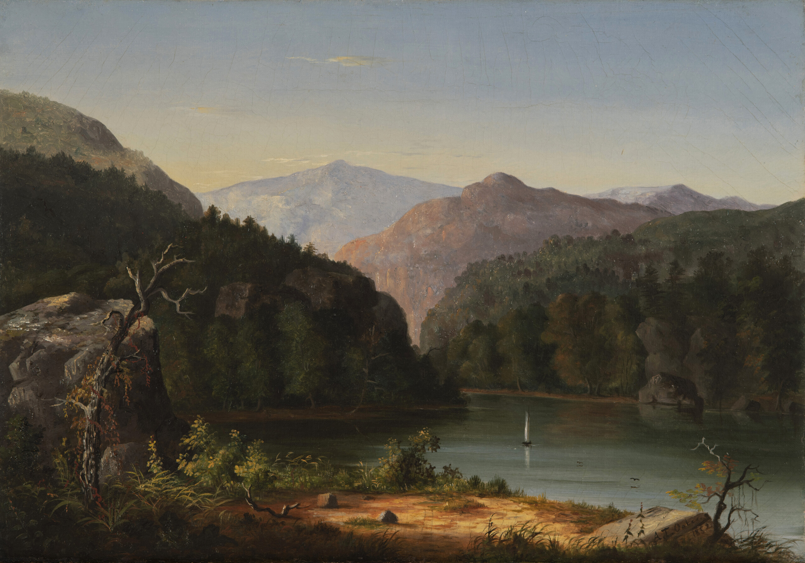 In this landscape painting, a glassy river cuts through forest and mountains, which rise in the distance against a clear blue sky. On the valley floor, the banks of the river show sand and foliage, while the forest is dense and dark.