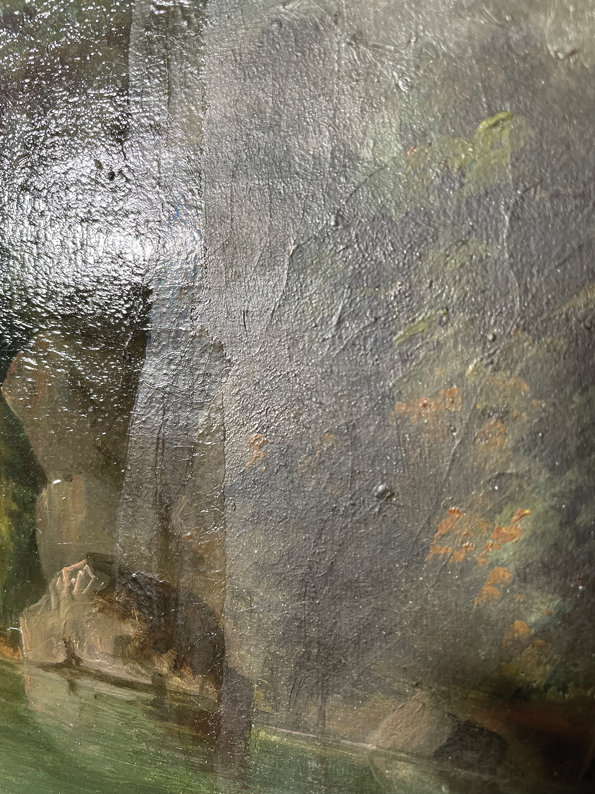 A close-up view of a painting’s canvas shows a portion of the left side with a glaring, shiny varnish, while the right side is in a matte finish after the varnish has been removed.