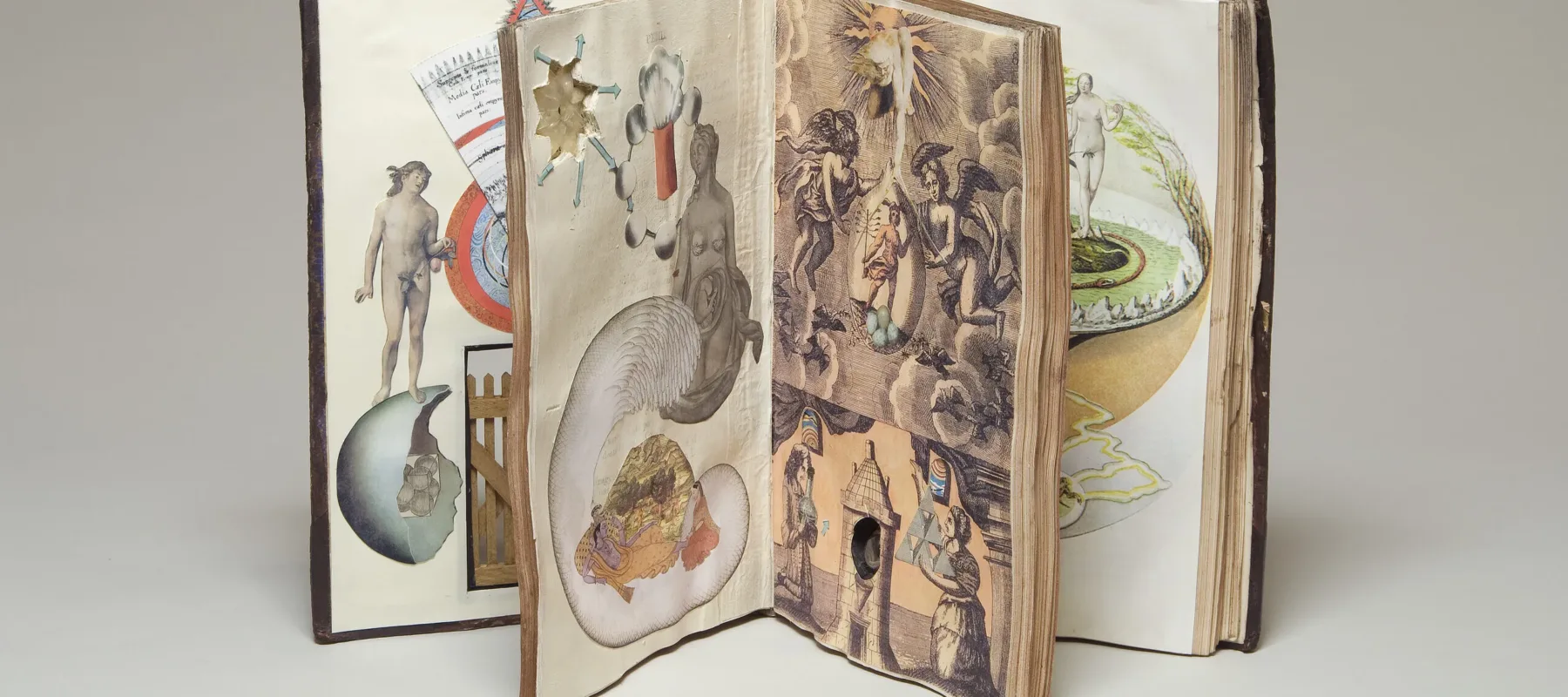 A weathered book with a cracking spine is filled with collages made up of mythological and scientific imagery.