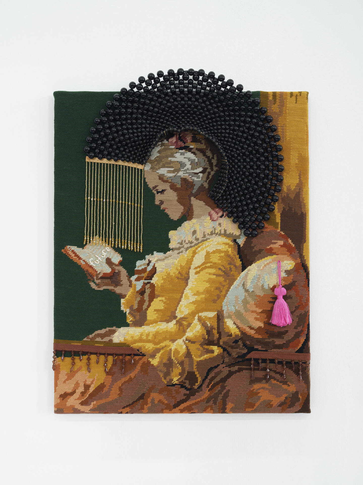 A needlepoint depicting, in profile, a seated, young girl with medium skin tone and dark hair in a yellow dress reading a book. A halo of black beads surrounds her bowed head.