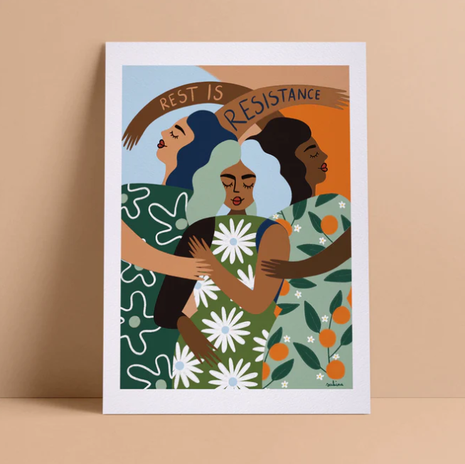 A print with an illustration of three women standing back to back, holding each other with one hand. They have medium and dark skin tones. The title reads "Rest is resistance."