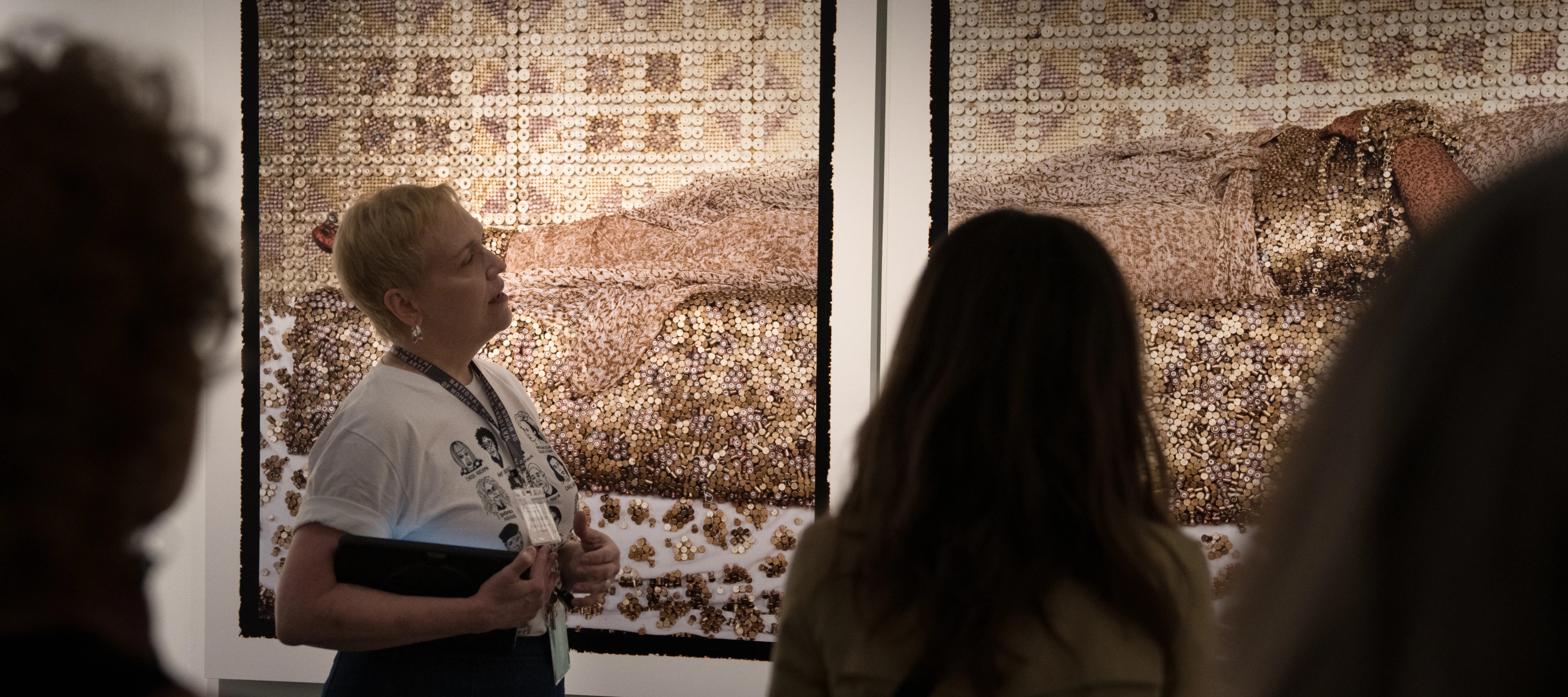 Museum visitors attend a docent-led tour.