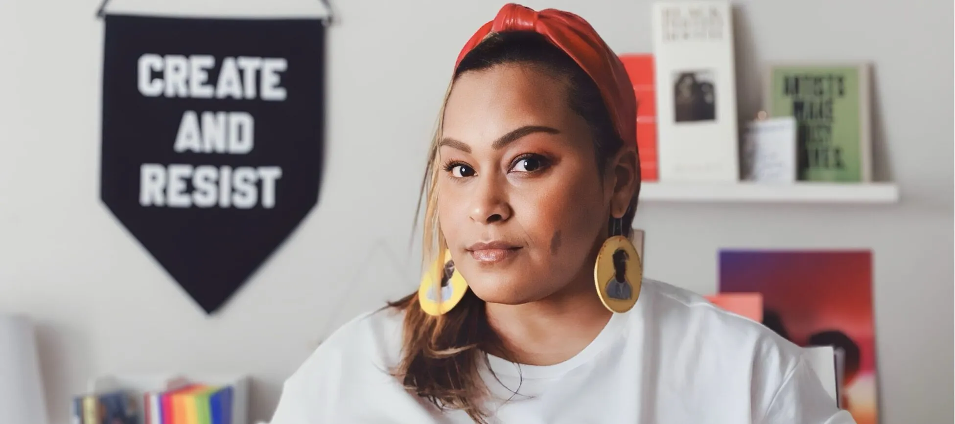 Photo of Artist and Designer Jen White-Johnson, an Afro-Latina Woman standing in her studio.