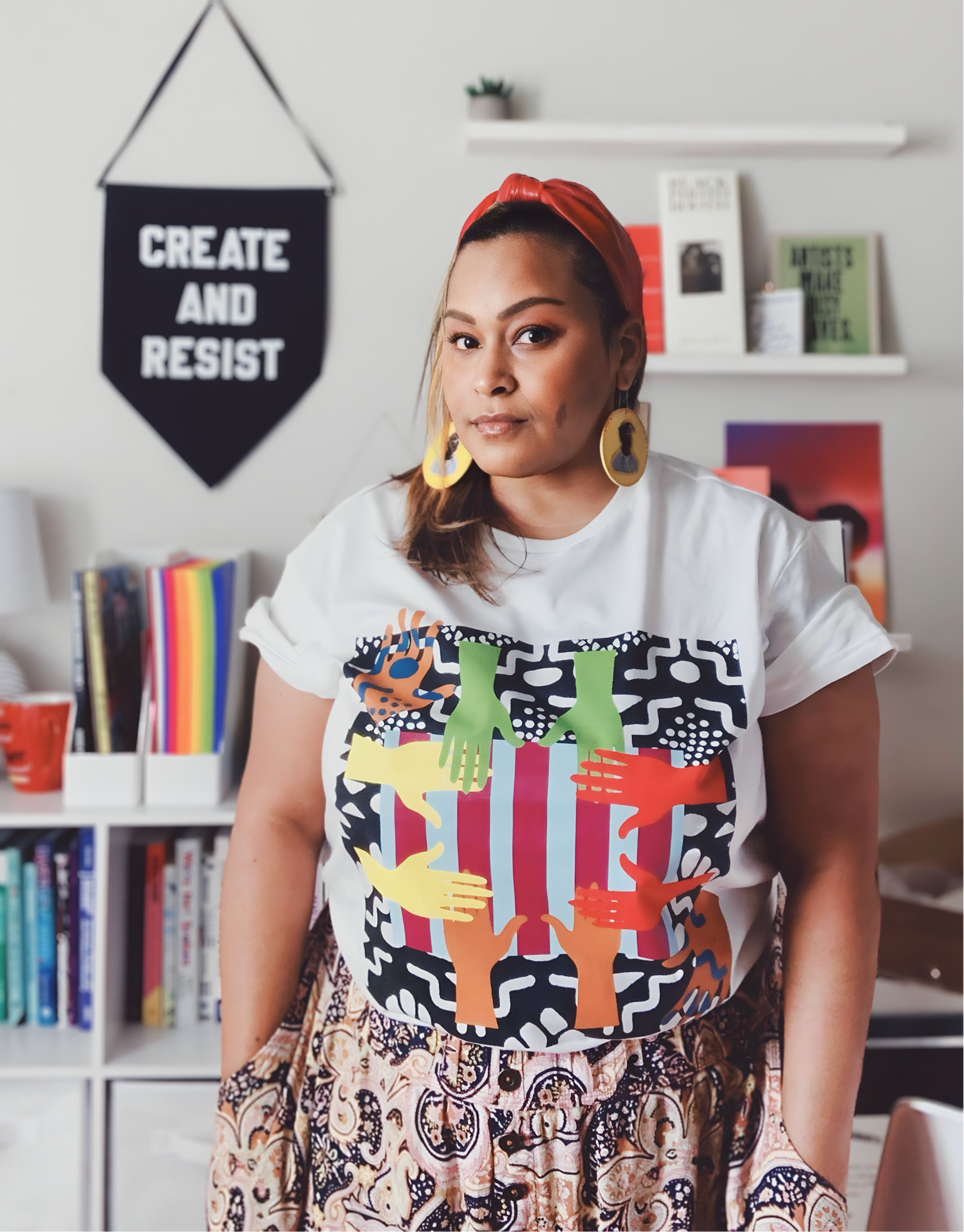 Photo of Artist and Designer Jen White-Johnson, an Afro-Latina Woman standing in her studio.