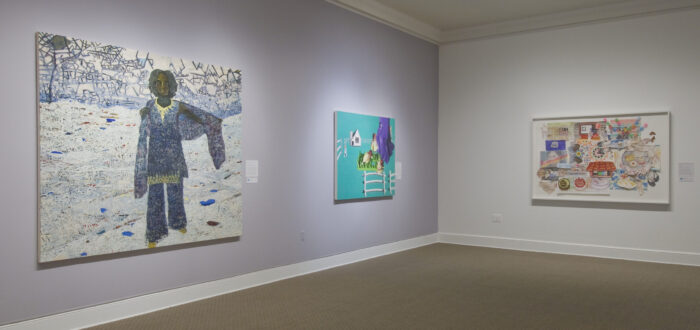 Two large paintings hang on a lavender wall. In the first, a dark-skinned woman stands in a white landscape, and in the other, a fence, house, and large birds float on a solid turquoise background. On the other white wall is an abstract multimedia work with houses, cakes, and patterns.