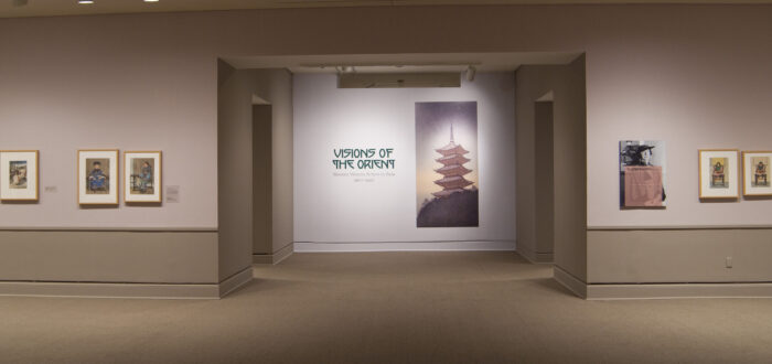 View of a gallery space. On a white wall, the text reads: "Visions of the Orient: Western Women Artists in Asia 1900–1940."