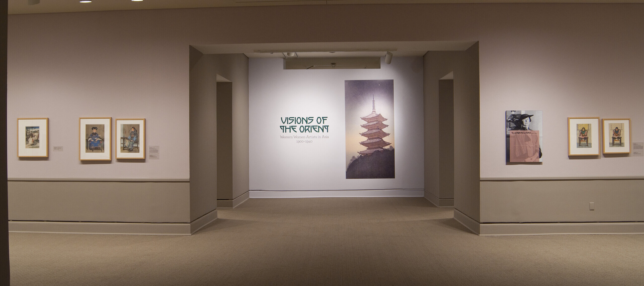 View of a gallery space. On a white wall, the text reads: 