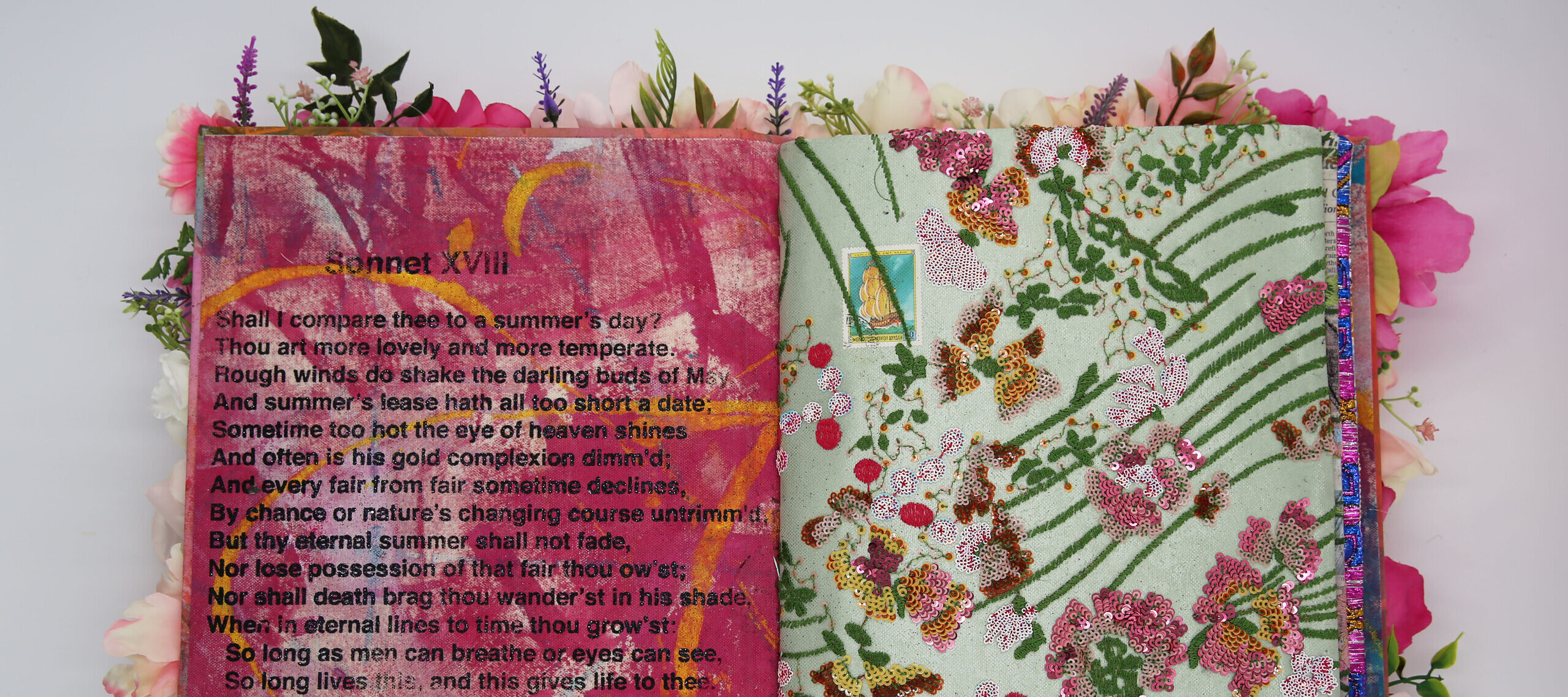 A photo of an artist's book, open in the middle. The left page displays Shakespeare's Sonnet XVII, and is painted in pink and yellow streaks. The right page has embroidered and sequined flowers and leaves.